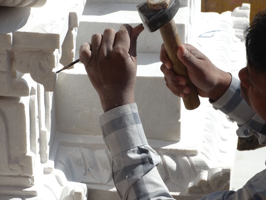 Close-up of an artisan crafting an intricate stone sculpture using hammer and chisel, Huizhou, Guangdong