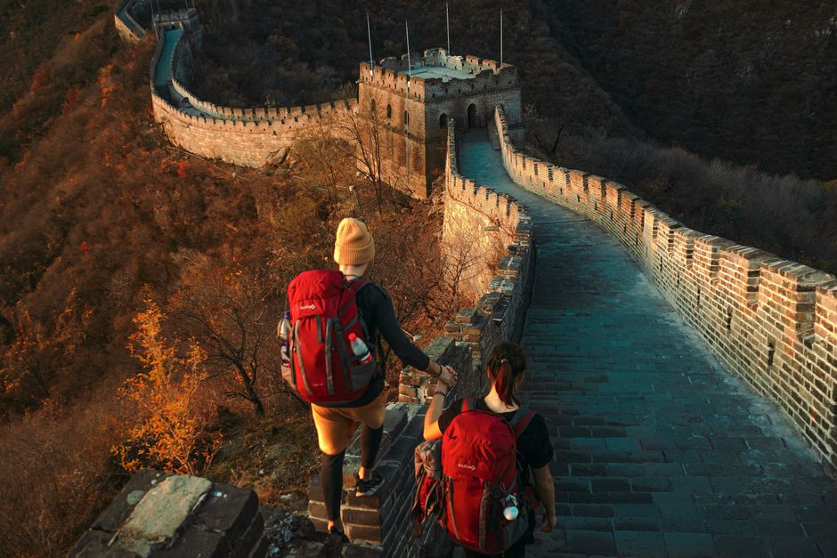Two hikers on Great Wall, exploring ancient architecture during a sunny autumn day, Huizhou, Guangdong