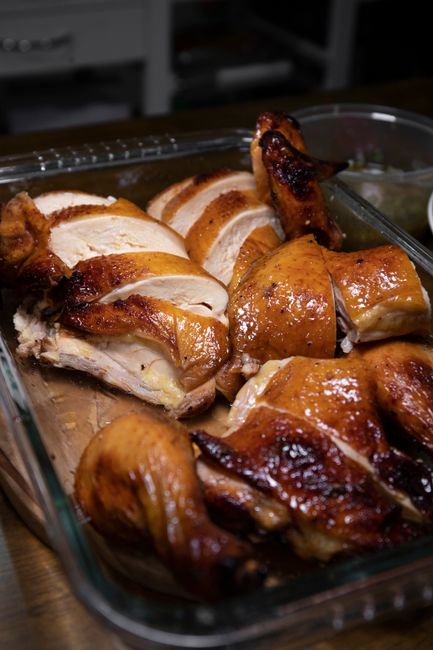Succulent roasted chicken pieces displayed in a clear baking dish, deliciously golden and ready to serve, Huizhou,...
