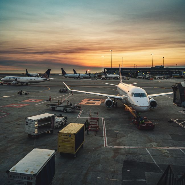 Airplanes parked at a busy airport terminal during sunset, showcasing aviation and travel, Huizhou, Guangdong