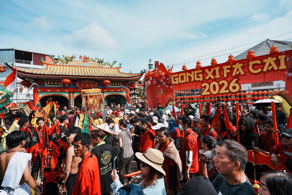 Vibrant Chinese New Year festival celebrations at a temple in Singkawang, Indonesia, with a lively crowd and festive...
