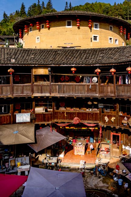 Authentic Fujian Tulou courtyard decorated with red lanterns, showcasing traditional Chinese architecture.