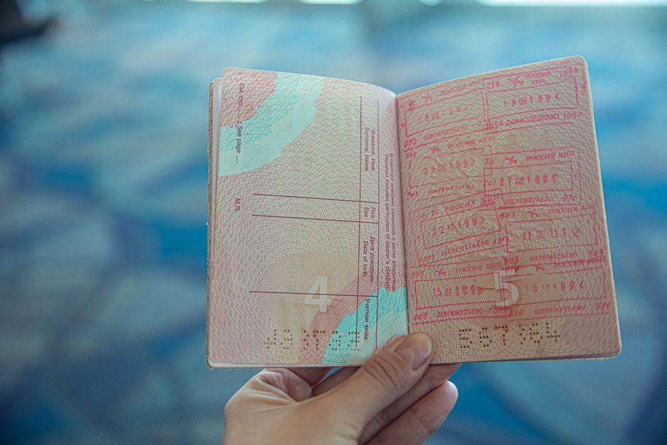 International travelers arriving at modern China airport with immigration signs