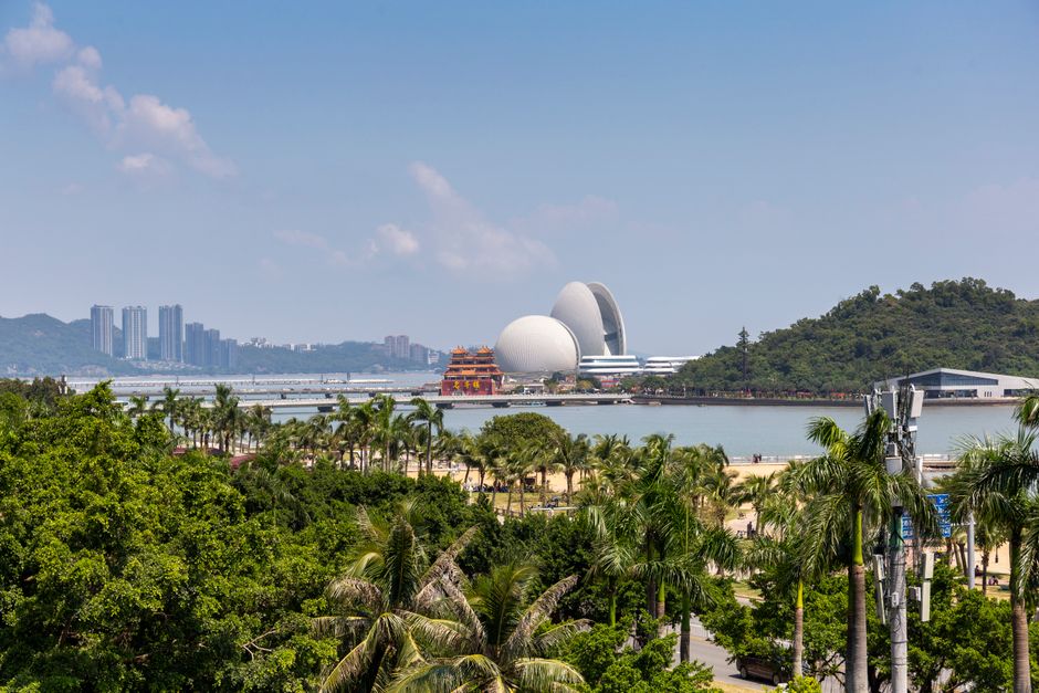 Scenic view of Zhuhai city skyline with lush greenery and iconic opera house. — Huizhou, Guangdong, China