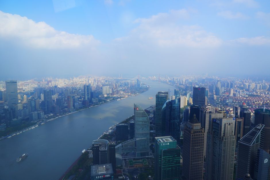 A breathtaking aerial cityscape of Guangdong, China, featuring skyscrapers along the Huangpu River.